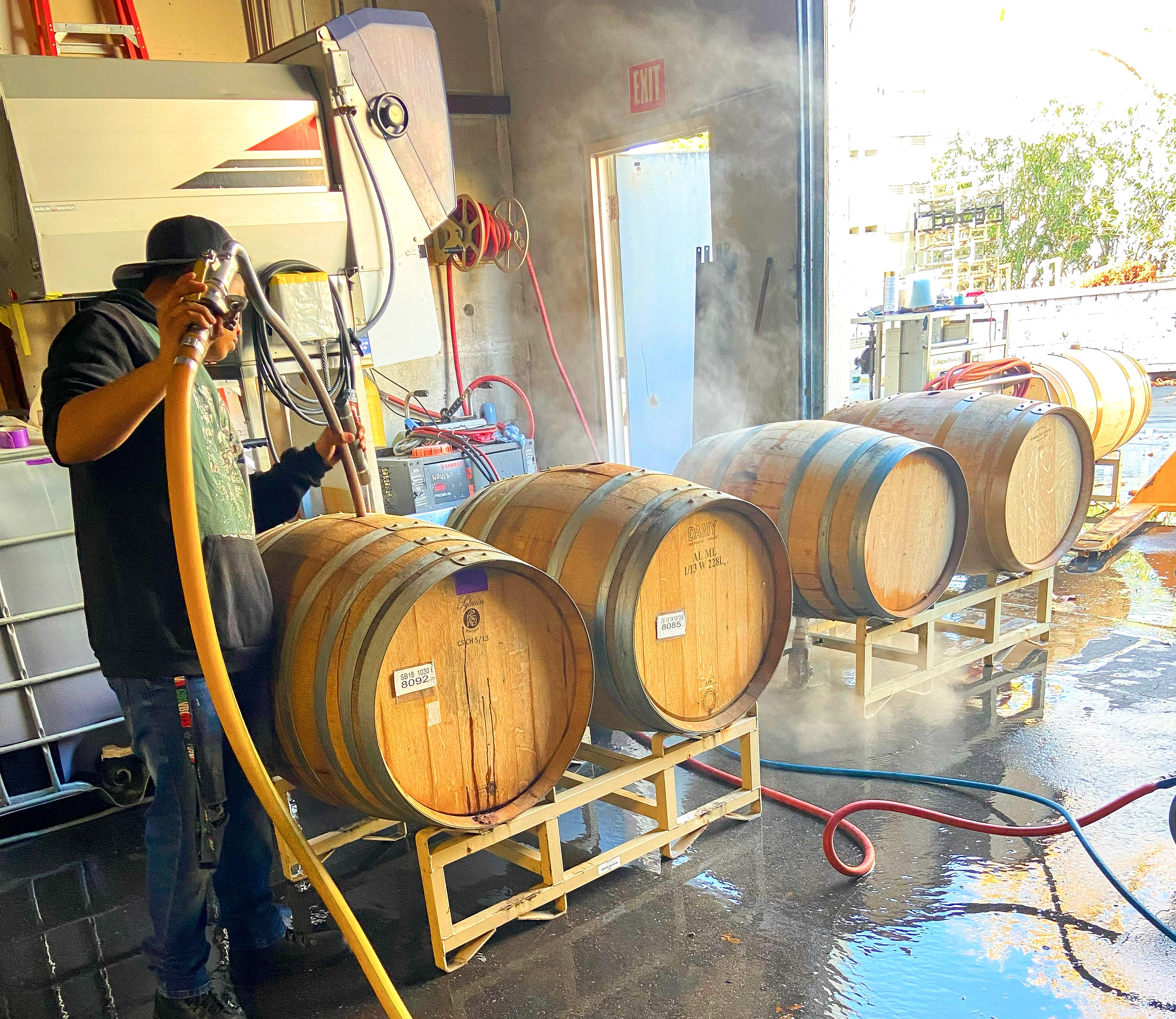 Wine being poured into barrels for aging at Red Brick Winery in Napa Valley