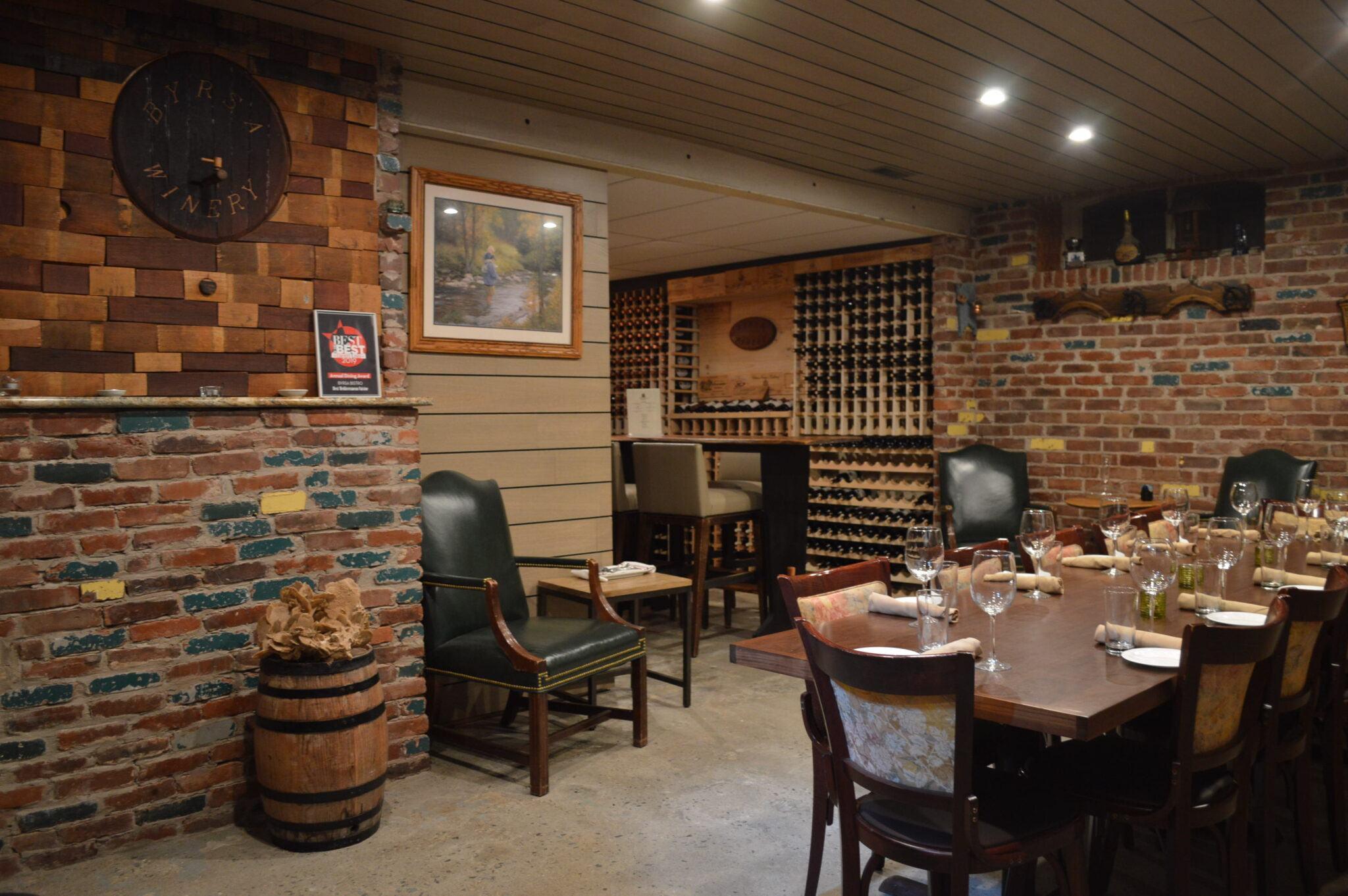 Exterior view of a rustic building with a surrounding vineyard landscape, perfect for Napa Valley wine tastings.